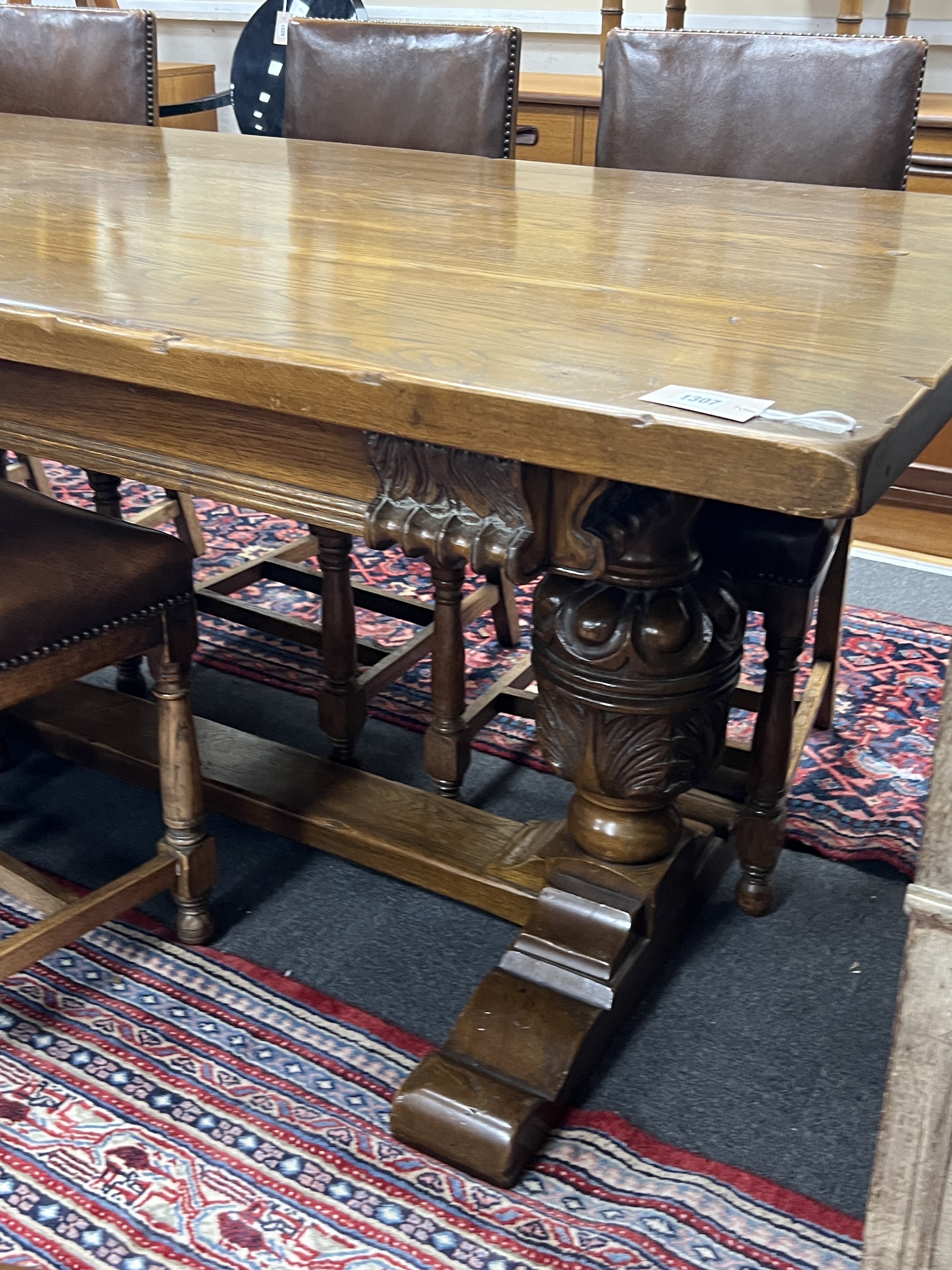 An 18th century style oak refectory dining table, length 198cm, height 76cm and eight oak dining chairs, two with arms